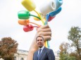 US artist Jeff Koons poses next to his sculpture Bouquet of Tulips, after the unveiling, near The Petit Palais Museum i