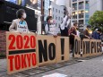 May 17, 2021, Tokyo, Japan: Protesters wearing masks hold signs in a line to form the words 2020 No! Olympics during an