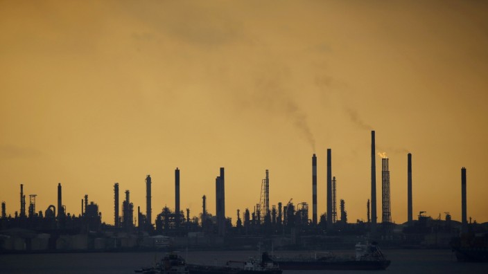 FILE PHOTO: Storm clouds gather over Shell's Pulau Bukom oil refinery in Singapore