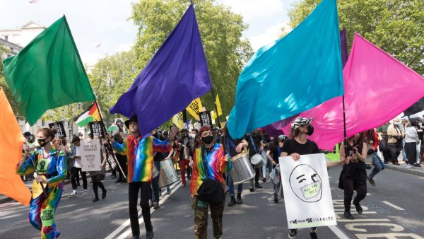 May 29, 2021, London, United Kingdom: LGBTQ representatives dressed up with rainbow-coloured fabric wave flags during t