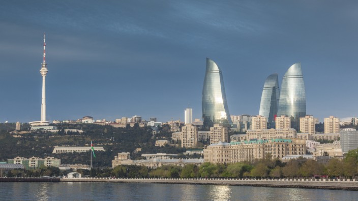 Azerbaijan, Baku, city skyline with Baku Television Tower and Flame Towers form Baku Bay, dawn. (Walter Bibikow)