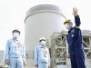 Mihama nuclear power plant in Japan File photo taken April 24, 2021, shows Fukui Gov. Tatsuji Sugimoto (L) visiting the