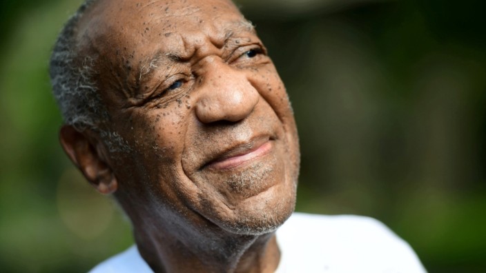 Bill Cosby looks on outside his house after Pennsylvania's highest court overturned his sexual assault conviction and ordered him released from prison immediately, in Elkins Park