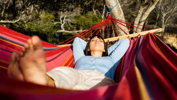 young woman caucasian sleeping in hammock Sant Elm, IB, Spain PUBLICATIONxINxGERxSUIxAUTxONLY CR_PESU210416-706701-01 ,