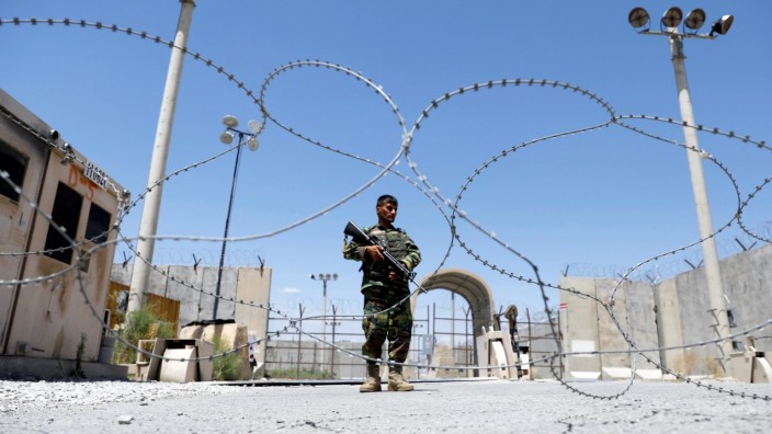 Afghan National Army soldier stands guard at Bagram U.S. air base gate on day of troop departure