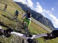 Italy Livigno View of woman and man riding mountain bike downhill model released PUBLICATIONxINxGE