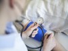 Close-up of doctor taking blood pressure of patient in medical practice model released Symbolfoto PUBLICATIONxINxGERxSU