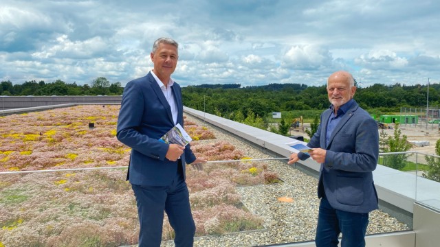 Wirtschaft in Fürstenfeldbruck: Geschäftsführer Jan Hoppenstedt (links) und Aufsichtsratschefs Erich Raff auf der Dachterrasse (rechts hinten die Baustelle des Sportzentrums).