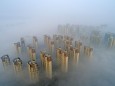 XIANGYANG, CHINA - DECEMBER 10: Aerial view of buildings shrouded in fog on December 10, 2020 in Xiangyang, Hubei Provin