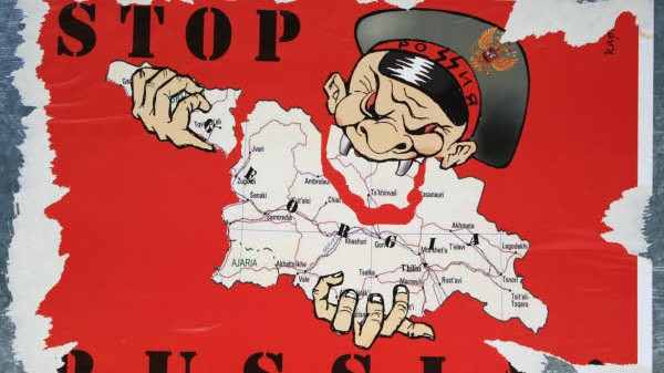 Kaukasus-Konflikt: "Stoppt Russland" steht auf einem Plakat in Tiflis. Doch auch Georgien ist nicht ganz unschuldig an dem Konflikt.