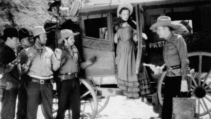 RIDERS OF THE FRONTIER, from far left: Roy Barcroft, Jean Joyce (exiting stagecoach), Tex Ritter (far right), 1939 Court