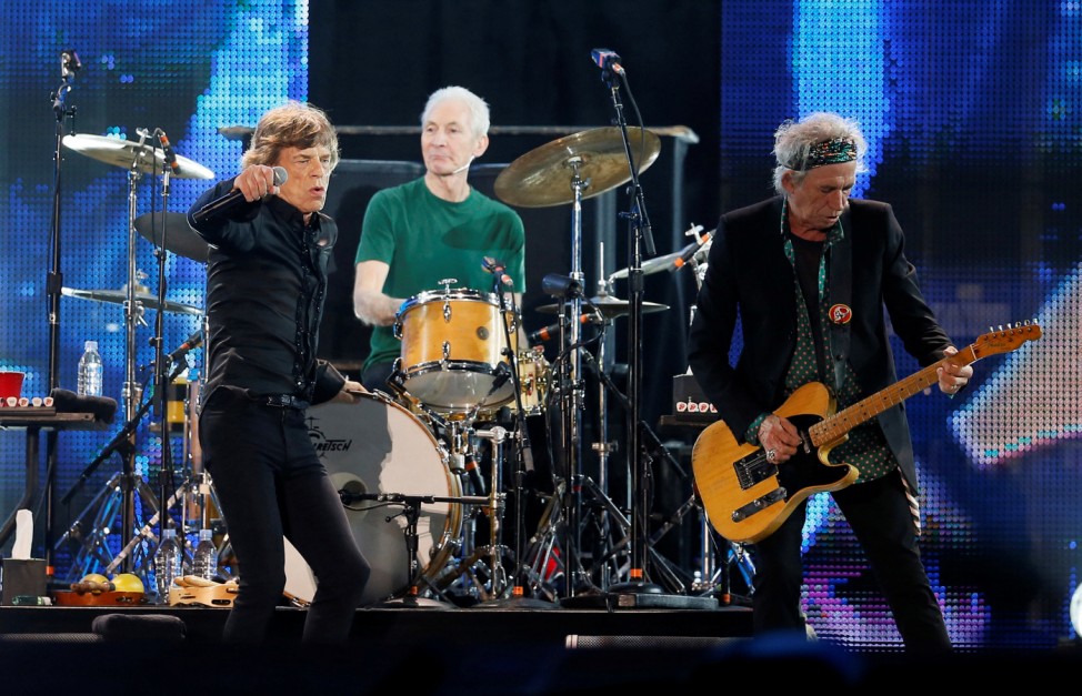 FILE PHOTO: Mick Jagger, Charlie Watts and Keith Richards of the Rolling Stones perform during a concert in Abu Dhabi