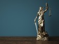 Lady Justice Statue Wooden Table Lady justice statue on the wooden table. 3d illustration.