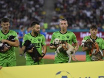 FCSB v Dinamo Bucharest - Romanian First League Catalin Itu, Alexandru Rauta, Deniz Giafer and Costin Amzar hold dogs in