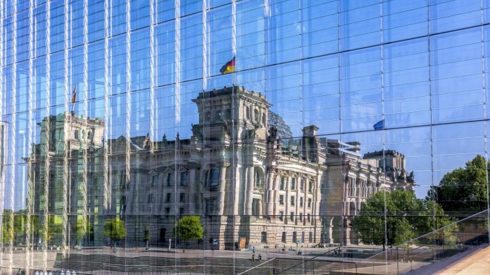 Germany Berlin Reichstag building mirrored in glass facade of Marie Elisabeth Lueders Building PUB