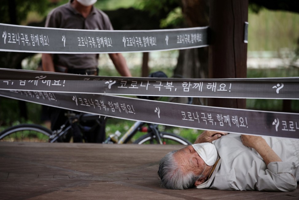 A man rests at a pavilion which has been cordoned off as a measure to avoid the spread of the coronavirus disease (COVID-19) at a park in Seoul