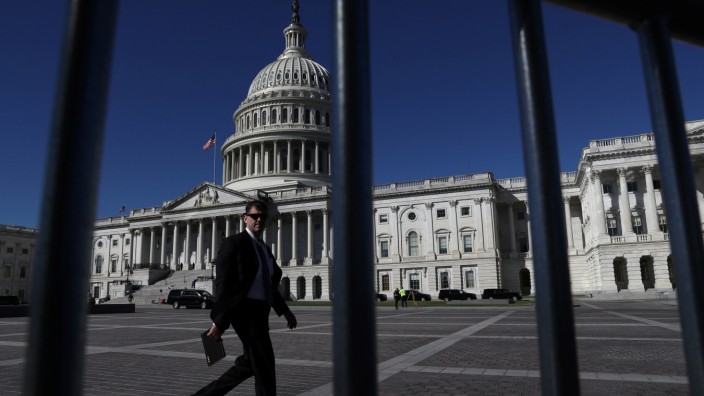 A man walks past the U.S. Capitol building as a government shutdown looms in Washington
