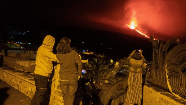 People look at the volcano in eruption from Tajuya in La Palma, Canary Islands, Spain, early 05 October 2021. The main