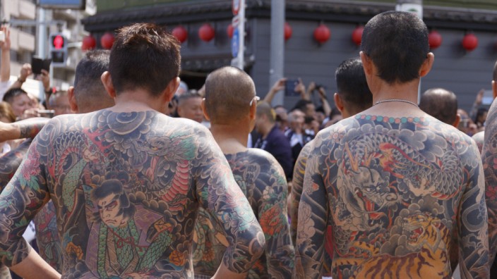 Participants showing their full body tattooed, possibly members of the Japanese mafia or Yakuza, attend the Sanja Matsuri in Asakusa district on May 20, 2018, Tokyo, Japan. The Sanja Matsuri is one of the largest Shinto festivals in Tokyo, and it is held