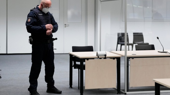 A judicial officer looks at his watch before a trial against the accused 96-year-old former secretary to the SS commander of the Stutthof concentration camp, in Itzehoe