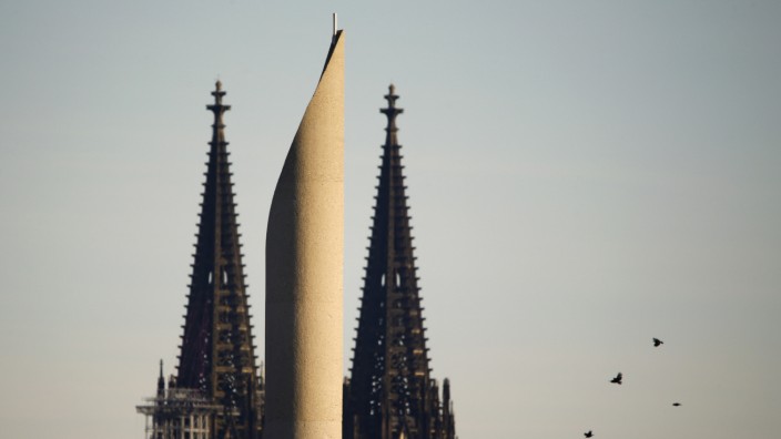 The Cologne Cathedral is seen behind to one of the two minarettes of the new Cologne Central Mosque