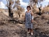 Greek Island Of Evia Strangles With Aftermath Of Wildfires And Drought A woman stands by her olive tree plantation near