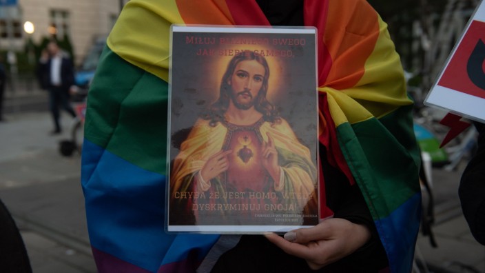 LGBT community protests proposed ban on pride parades. A demonstrator holds a placard depicting Jesus Christ on October