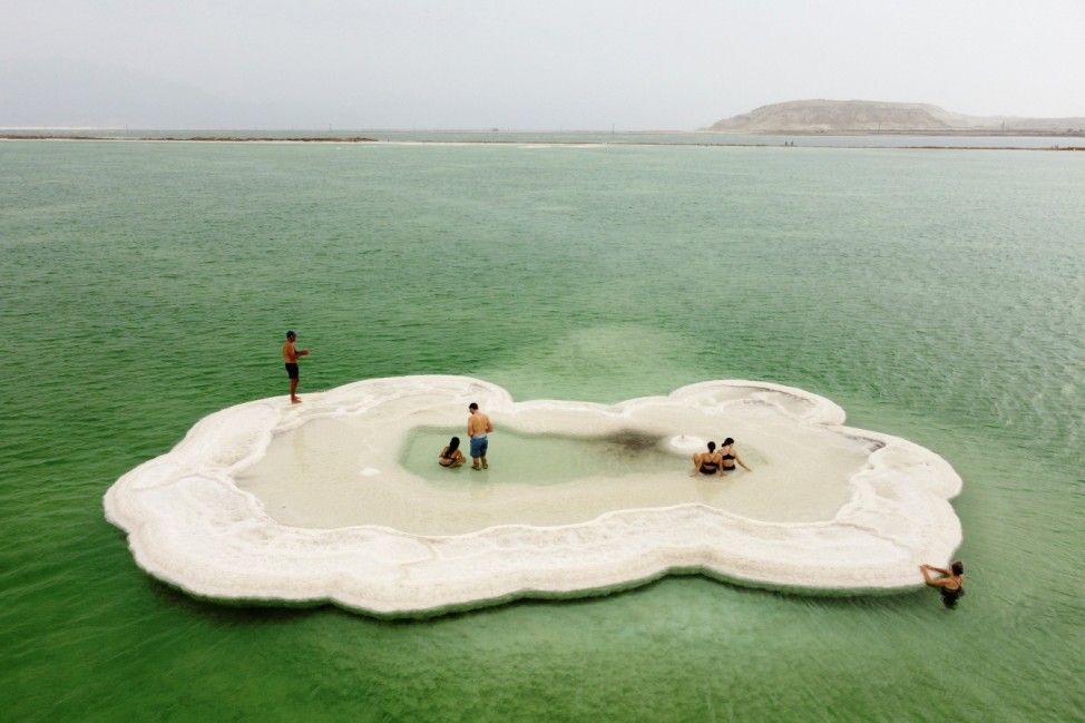 Visitors explore a salt formation in the Dead Sea