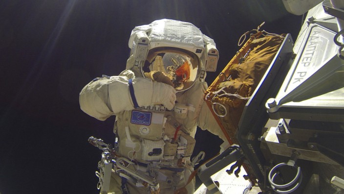International Space Station crew member Volkov performs spacewalk outside ISS