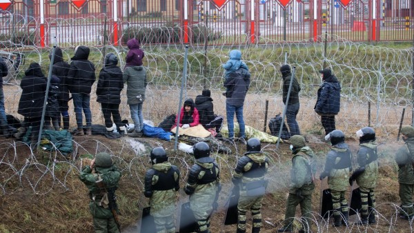 GRODNO REGION, BELARUS - NOVEMBER 13, 2021: Migrants and Belarusian servicemen at a camp on the Belarusian-Polish border