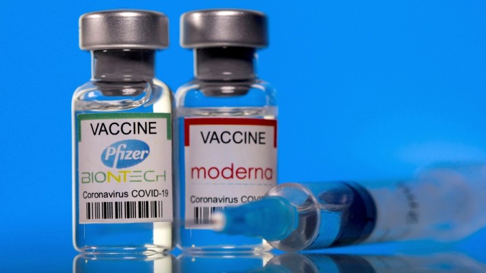 FILE PHOTO: Picture illustration of vials with Pfizer-BioNTech and Moderna coronavirus disease (COVID-19) vaccine labels