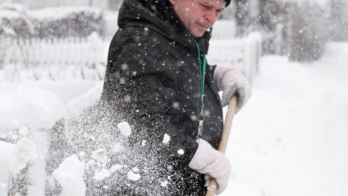 Tuerkenfeld: WINTEREINBRUCH  / Mann beim Schneeraeumen des Gehweges