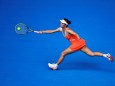 FILE PHOTO: Peng Shuai of China hits a return to Maria Kirilenko of Russia during their women's singles match at the Australian Open tennis tournament in Melbourne