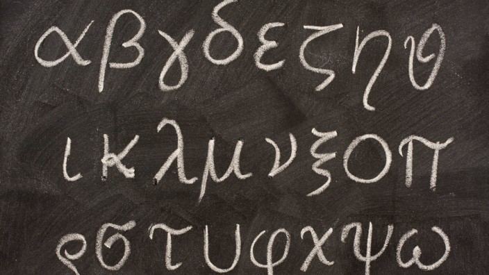 Greek alphabet on blackboard twenty four letters of Greek alphabet from alpha to omega (in lower case) handwritten with