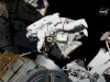 Astronauts conduct a spacewalk to replace a faulty antenna on the International Space Station
