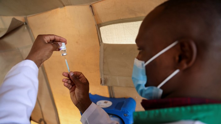 Healthcare professional prepares a dose of AstraZeneca (COVID-19) vaccine, in Narok