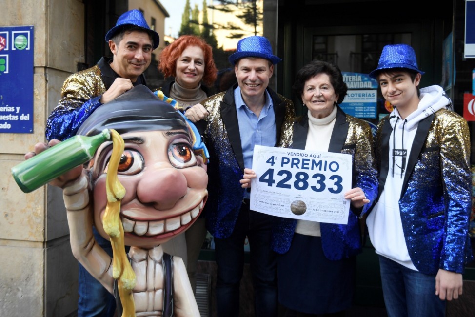 Workers of a lottery administration celebrate they have sold one of the fourth prizes prize of El Gordo traditional Spa