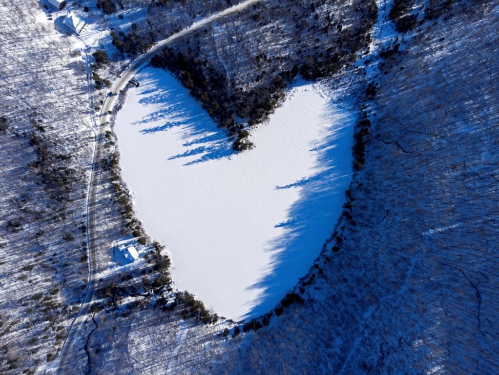 Snow covers the heart-shaped and frozen Baker Pond on Christmas Eve in East Bolton