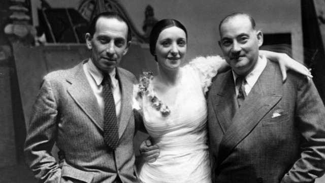Biografie: Komponist Paul Abraham (links) zusammen mit der Hauptdarstellerin Anny Ahlers und dem Direktor des Metropoltheaters Paul Rotter 1931 bei der Premiere von "Die Blume von Hawai".