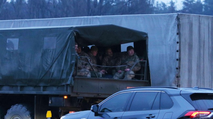 Ukraine Russia Military Operation 8124765 24.02.2022 Ukrainian servicemen ride in the back of a military truck in Kiev,
