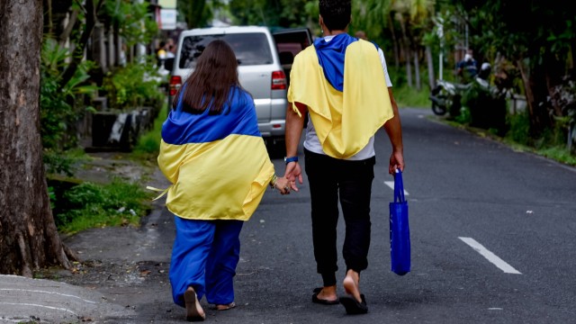 Stranded in paradise: Ukrainians have also been stranded in Bali, like this couple, who use the Ukrainian national flag in Denpasar to draw attention to the situation in their homeland.