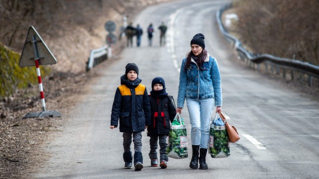 War and gender: actors at risk: a woman and two children shortly after crossing the border between Ukraine and Slovakia.