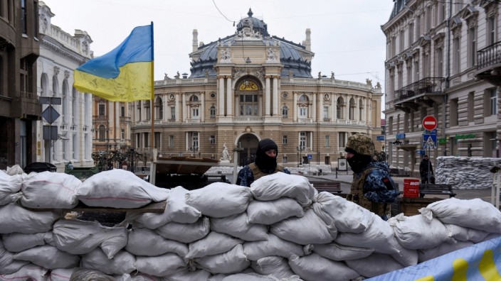 FILE PHOTO: Soldiers stand guard behind a barricade, with the Odessa National Academic Opera and Ballet Theatre seen in the background, amid Russia's invasion of Ukraine, in Odessa