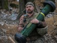 Ukrainian service member holds a Javelin missile system at a position on the front line in the north Kyiv region