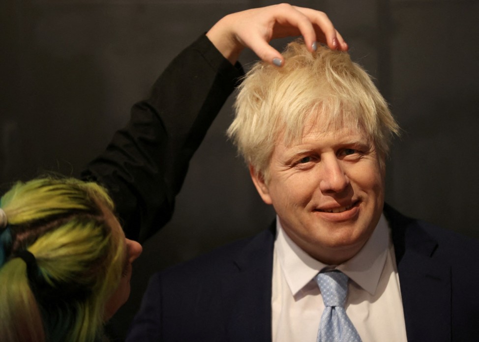 Emma Meehan, a waxworks artist adds finishing touches to the Boris Johnson waxwork figure during the unveiling at Madame Tussauds in Blackpool