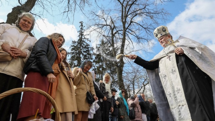 Christlich-orthodoxe Kirche: Beim Ostergottesdienst vor der Wladimir-Kathedrale in Kiew segnet ein Priester Gläubige.