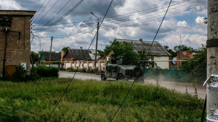 May 27, 2022, Siversk, Ukraine: An armoured military vehicle with mounted machine gun on top passes in the streets of th