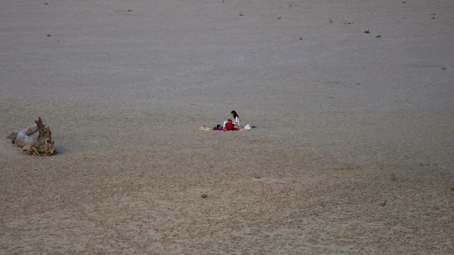Hitzewelle: Kein Wasser: Ein junges Paar liegt am ausgetrockneten Flussbett des Po in Boretto.