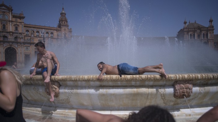 Wetter: Erhitzte kühlen sich im Brunnen auf der Plaza de Espana in Sevilla ab.
