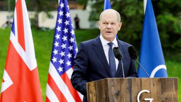 German Chancellor Olaf Scholz addresses the media following the G7 summit